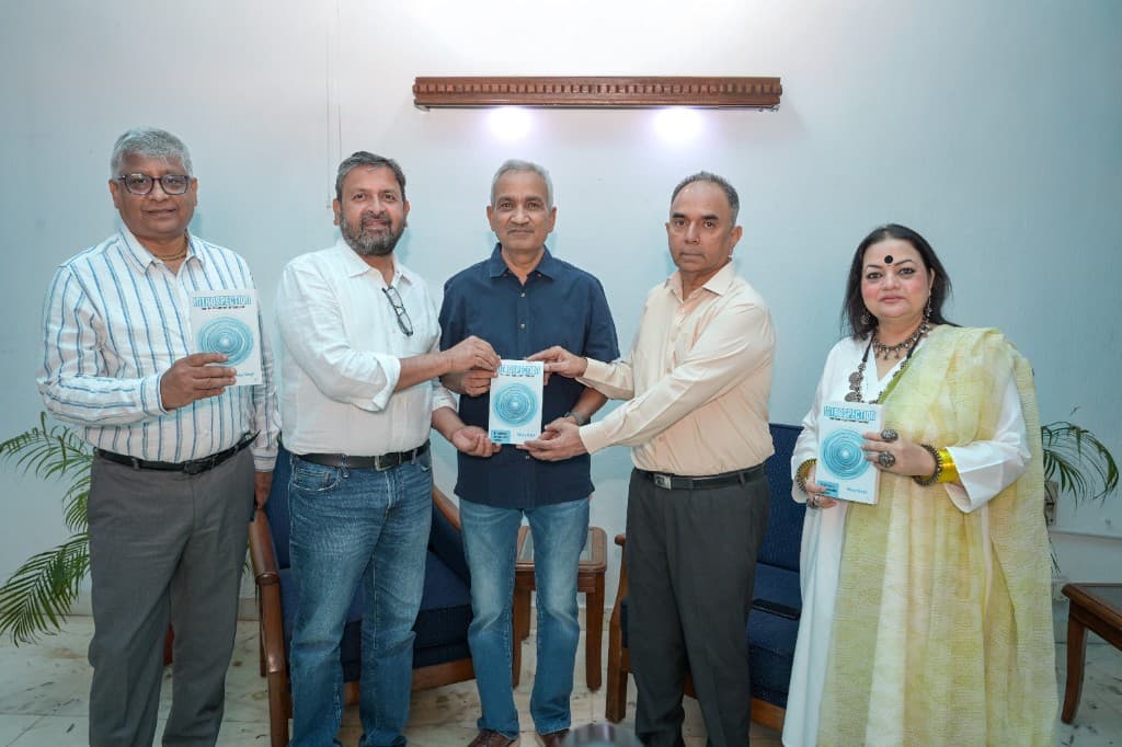 Author and key contributors holding copies of Introspection at the book launch