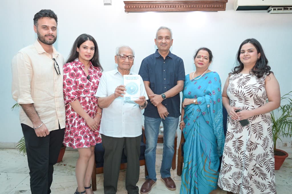 Vinay Singh with family holding a copy of Introspection at the book event
